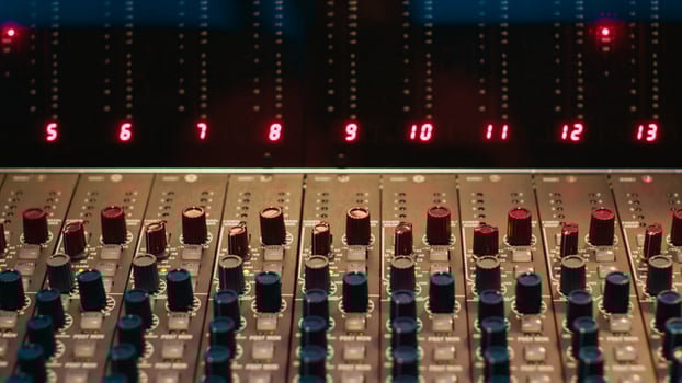 Empty professional studio with control desk mixer and pre amp knobs, music recording and editing with audio software. Control room buttons and sliders in post production, soundproof space. photo