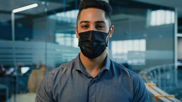 Close up headshot in office male business portrait ethnic multiracial multiethnic Hispanic Indian businessman manager entrepreneur executive guy worker man company CEO in medical protective face mask photo