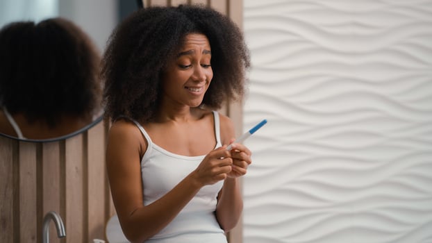 Happy excited African American girl with positive pregnancy test rejoice good medical insurance clinic artificial insemination pregnant future mom childbirth woman female successful fertility IVF photo