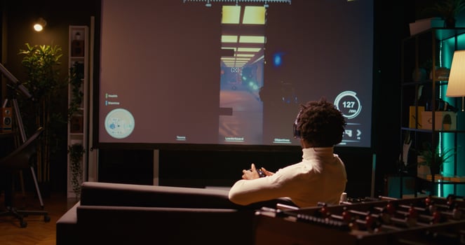 African american man playing shooter videogame on ultrawide TV with gun shooting laser bullets at flying robots. Panning shot of gamer enjoying competitive PvP fps internet multiplayer tournament game photo