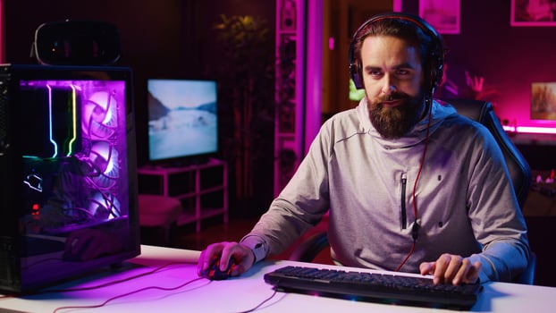 Panning shot of streamer talking with audience, filming tutorial on how to defeat enemies in multiplayer game. Professional gamer teaching fans competitive esports winning strategies photo