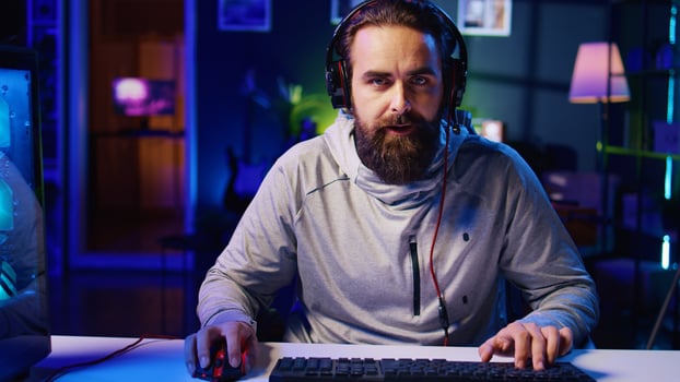 Gamer feeling upset after losing against opponent in online esports competition, failing to understand reason. Player punching desk after being defeated by enemy in videogame internet tournament photo