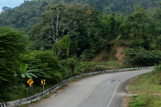 Asphalt road leading straight to the hills. Covered with lush green forest. Curved hill on the mountain. Mae Ngao Mae Hong Son of Thailand. photo