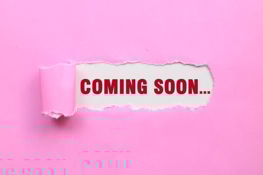 Coming soon message written on ripped torn pink paper. Text COMING SOON photo