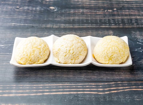 Chinese Barbecued Pork Buns served in tray dish isolated on wooden table side view of hong kong food photo