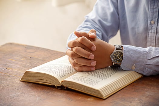 Christian man hand praying to god with the bible. photo