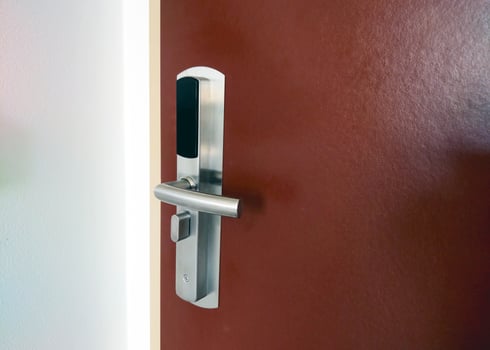 Modern Electronic Door Lock on Wooden Hotel Room Door for Security and Access Control photo