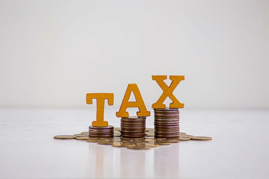 TAX Concept.Word tax put on coins with calculator and summary report on table. photo