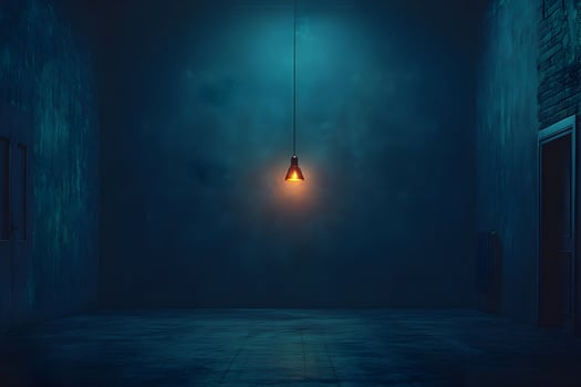 Dark room with single hanging lightbulb, grunge walls, and doors. photo