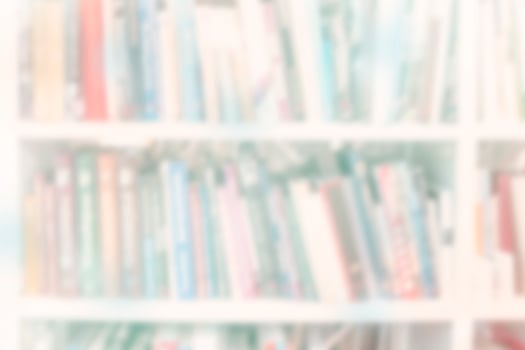 Blur bookshelf with books. Background with light colors. photo
