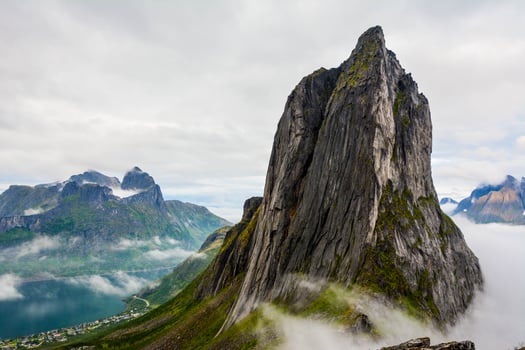 View from Mount Hesten on Iconic Mountain Segla in light of epic sunsetcovered in fog. High quality photo.Copy space. photo