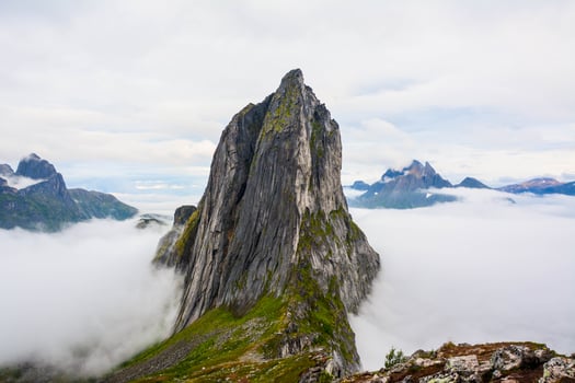 View from Mount Hesten on Iconic Mountain Segla in light of epic sunsetcovered in fog. High quality photo