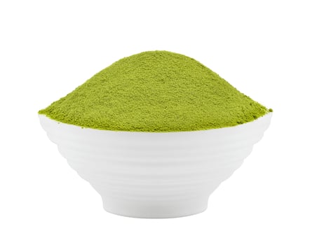 green tea powder in a bowl on white background photo