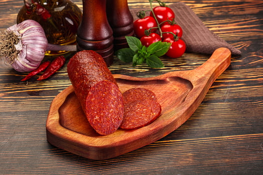 Spicy pepperoni sausages with sliced piece photo
