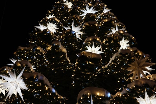 A Beautiful and Festive Christmas Tree Adorned with Glowing Ornaments and Shining Stars photo