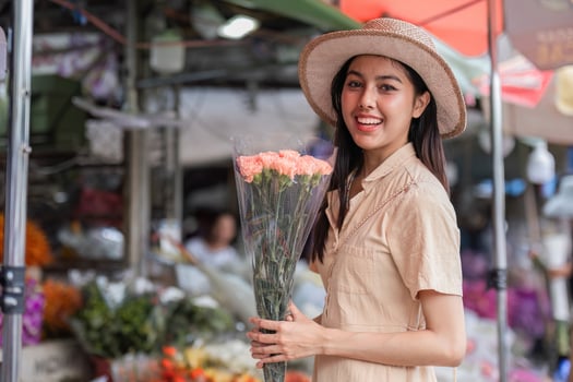 Young Woman Enjoying a Vibrant City Walk with Flowers in Hand, Embracing Urban Lifestyle and Fashion photo