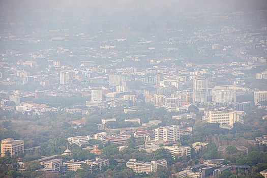 a plane flying over a city photo