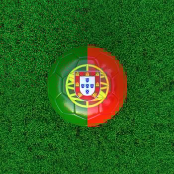Flag Of Portugal On Soccer Ball With Grass Background photo