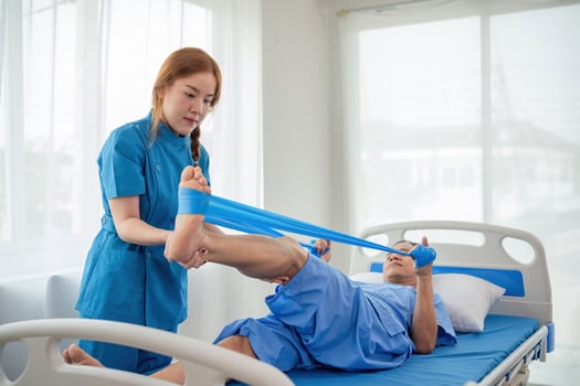 Young Caregiver Assisting Elderly Patient with Physical Therapy in a Bright Modern Hospital Room photo