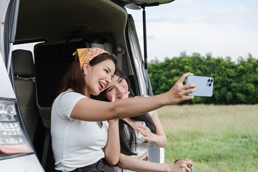 A young lesbian couple enjoyed driving out to see nature and taking picture together. photo