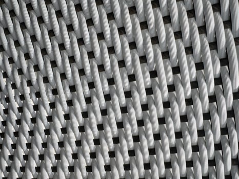 White woven texture displayed closely with a pattern of interlacing strands photo