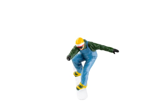 Miniature figurine depicting a snowboarder in mid-motion isolate on white background with clipping path photo