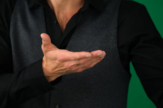 Businessman holding hand out in presentation on white background photo