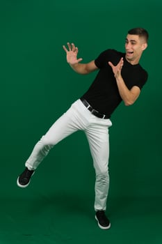Man in stylish outfit dancing on blue background photo