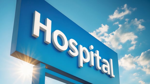 Bright hospital sign under the sun with a clear blue sky for medical facility identification photo