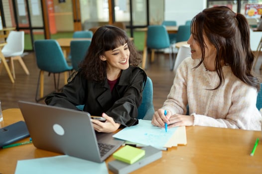 Friends Studying Together at a Cafe Working on Academic Projects photo