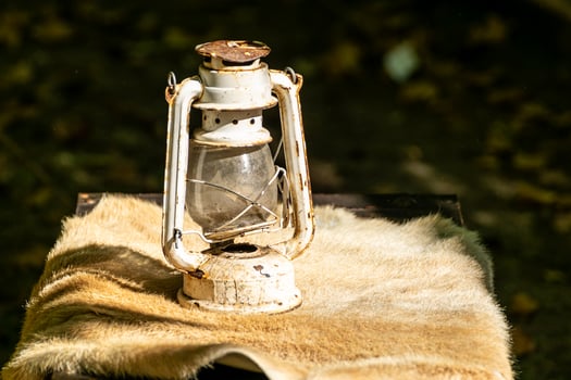 old and rusty candle on an animal skin, decoration for historical parties photo