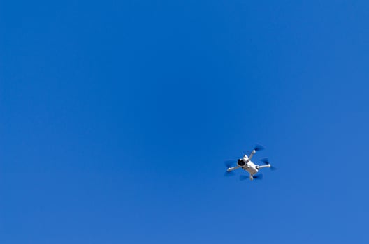 a mini drone that weighs less than 250 grams flying photo