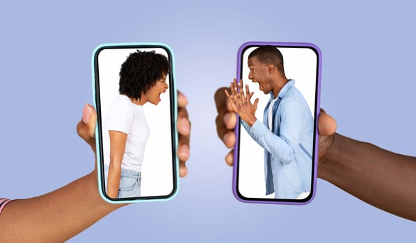 A couple engages in a heated conversation through their smartphones, conveying strong emotions while chatting. Their faces show tension as they express their feelings in different locations. photo