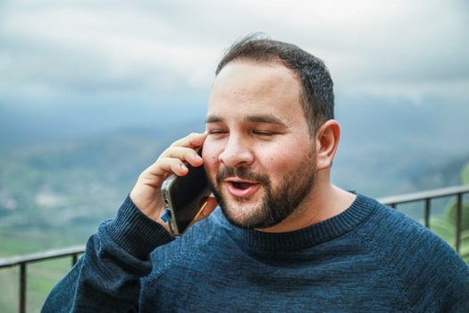 Man Smiles Brightly During Phone Call photo