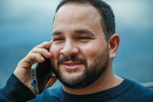 Joyful Reaction While Talking on the Phone photo