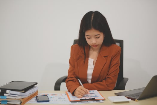 A driven and dedicated young professional showcases her efficiency and attention to detail as she works diligently on her laptop photo