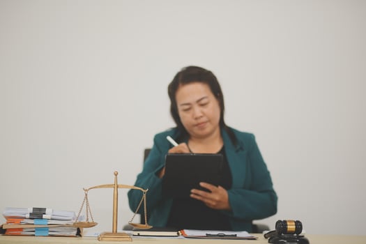 Pretty Asian female lawyer working and hammer, laptop, justice advice and legal concept. In office photo