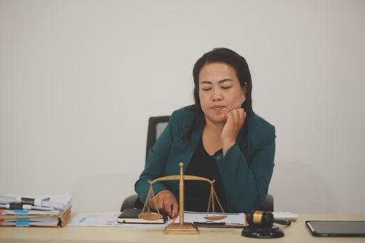 Pretty Asian female lawyer working and hammer, laptop, justice advice and legal concept. In office photo