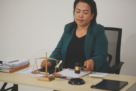 Pretty Asian female lawyer working and hammer, laptop, justice advice and legal concept. In office photo
