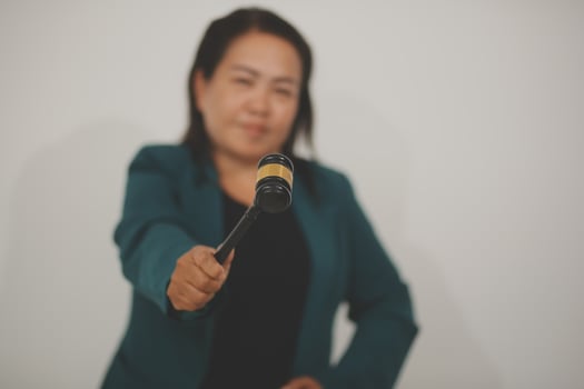 Pretty Asian female lawyer working and hammer, laptop, justice advice and legal concept. In office photo