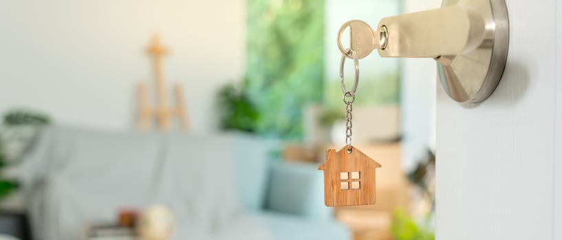The key was inserted into the door of the new house, inside the room was a cardboard box containing personal belongings and furniture. move in the apartment or condominium photo