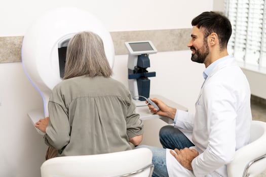 Senior woman undergoing eye exam with optometrist using modern equipment photo