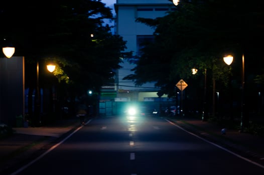 A street with a car driving down it photo