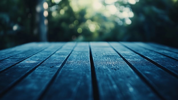 A blue wooden table with a view of trees in the background photo