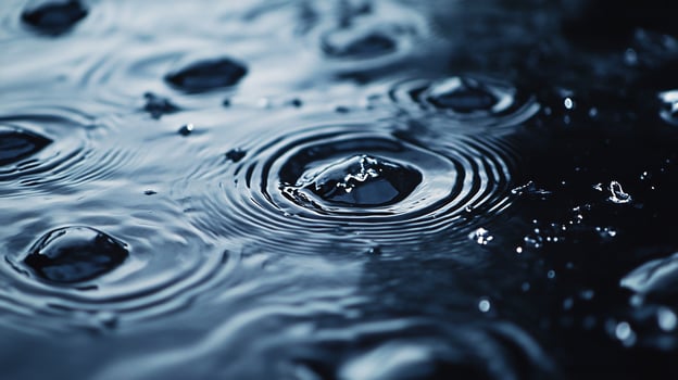 A body of water with raindrops falling on it photo