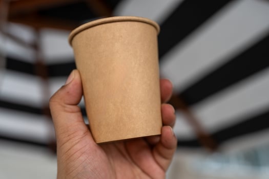 Hand holding takeaway coffee cup photo