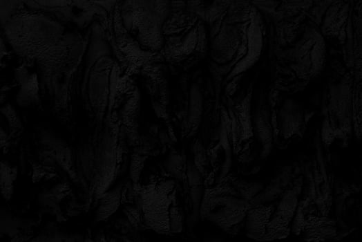 Abstract black background. Black stucco texture. Dark rough surface. Architectural stucco molding made of cement. photo