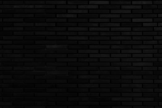 Black brick wall. Facade of an old building. Architectural background. photo