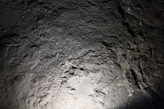 An Intimate CloseUp of a Textured Rock Surface Captured in Low Light Conditions photo