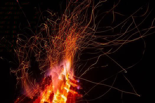 Sparks from a fire against dark night. Bonfire photo